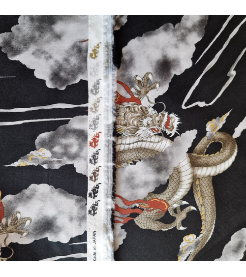 Japanese cotton fabric of dragons and clouds on black.