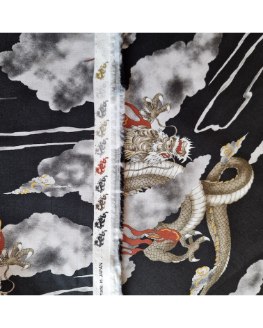 Japanese cotton fabric of dragons and clouds on black.
