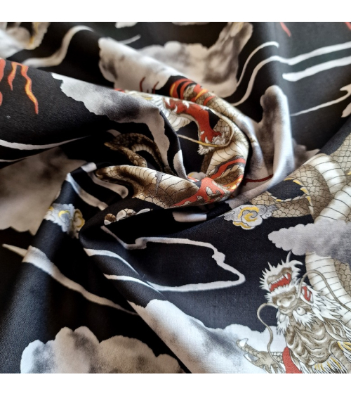 Japanese cotton fabric of dragons and clouds on black.