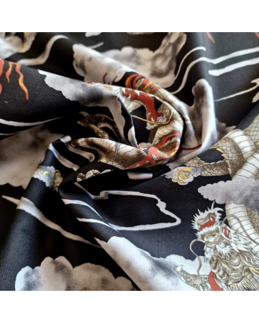 Japanese cotton fabric of dragons and clouds on black.