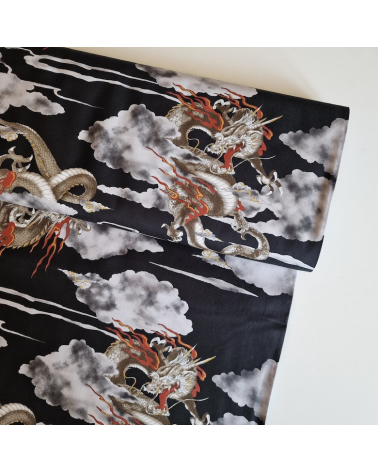 Japanese cotton fabric of dragons and clouds on black.