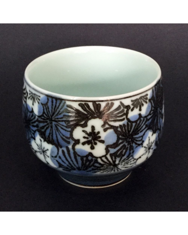 Bowl for tea with flowers of cherry in blue and black