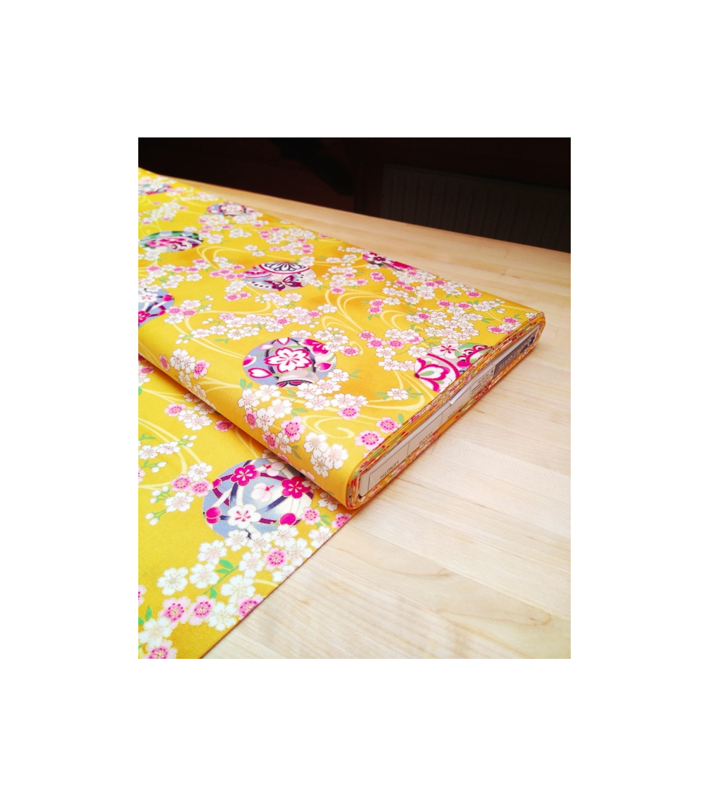 Japanese fabric. Sakura and temari over yellow.
