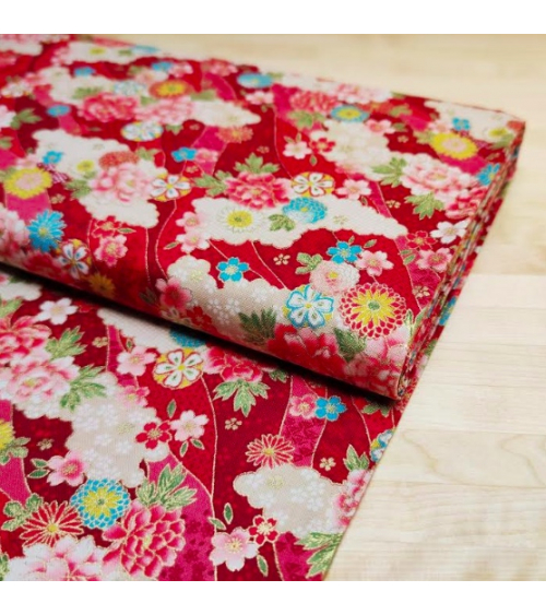 Japanese fabric. Flowers and clouds over red.