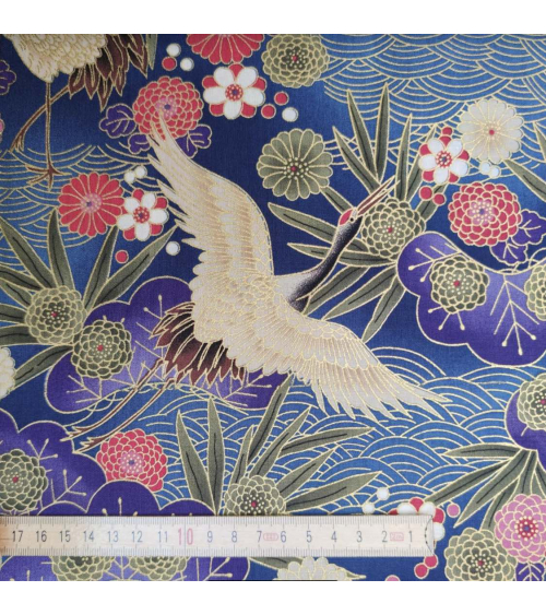 Japanese cotton fabric of cranes in blue with golden details.