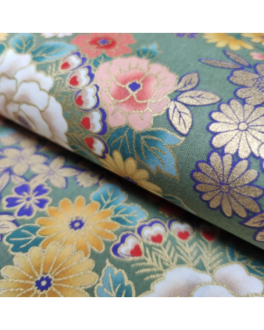 Japanese fabric with multicolor and golden flowers on green.