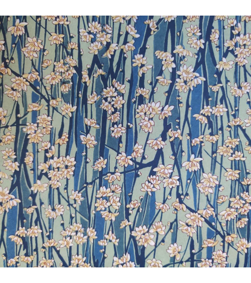 Japanese Chiyogami paper of magnolia flowers over blue and green