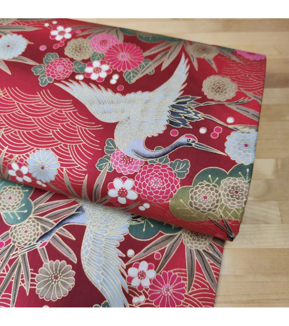 Japanese cotton fabric of cranes in red with golden details.