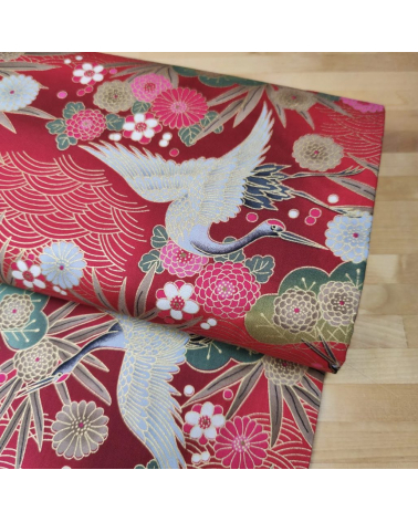 Japanese cotton fabric of cranes in red with golden details.