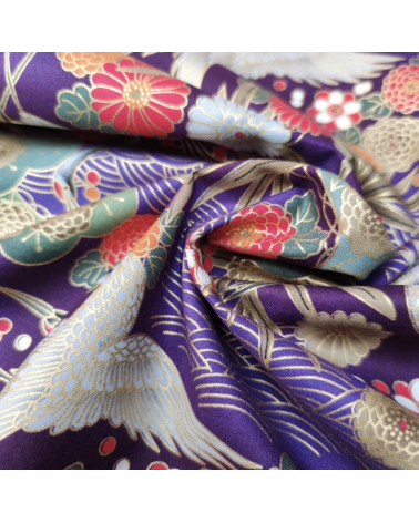 Japanese cotton fabric of cranes in violet with golden details.
