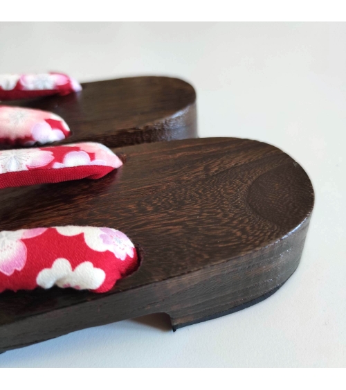 Geta sandals with cherry blossom (sakura) on a red background.