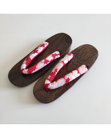 Geta sandals with cherry blossom (sakura) on a red background.