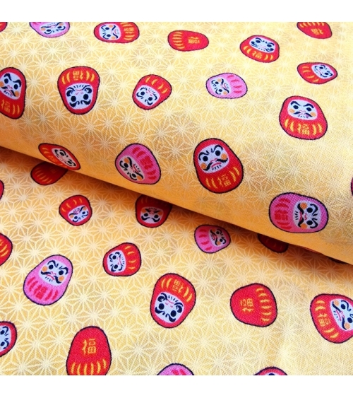 Japanese 100% cotton fabric "Darumas and asanoha" in yellow.