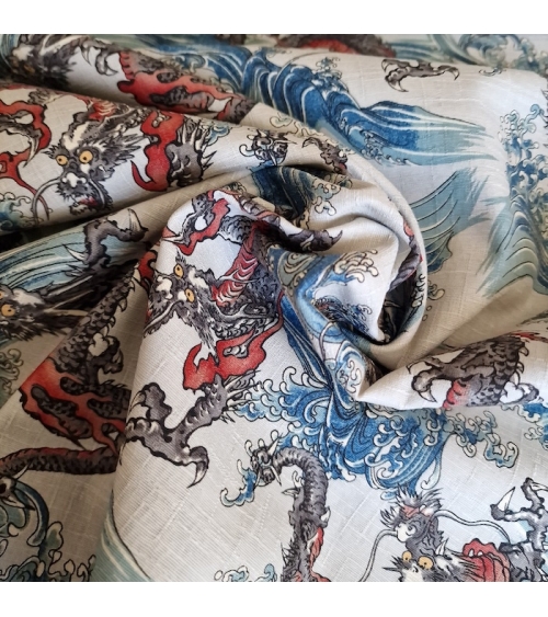 Japanese dobby fabric with small dragons and waves in bluish white.