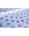 Japanese fabric of red and blue darumas on white